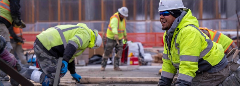 A crew of McGough construction workers pouring concrete on a job site