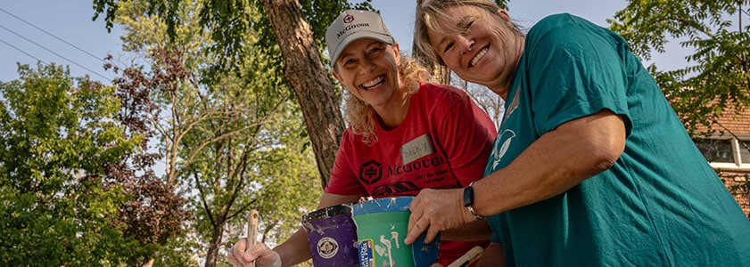 Two McGough employees volunteering on a community project