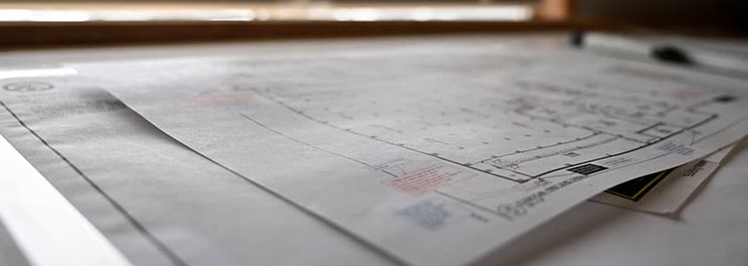 Image of blueprints and technical documents spread out on a table