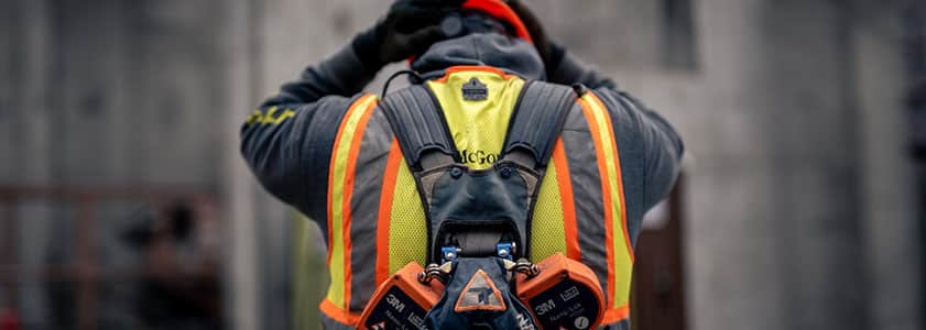 A McGough subcontractor seen from behind donning safety gear