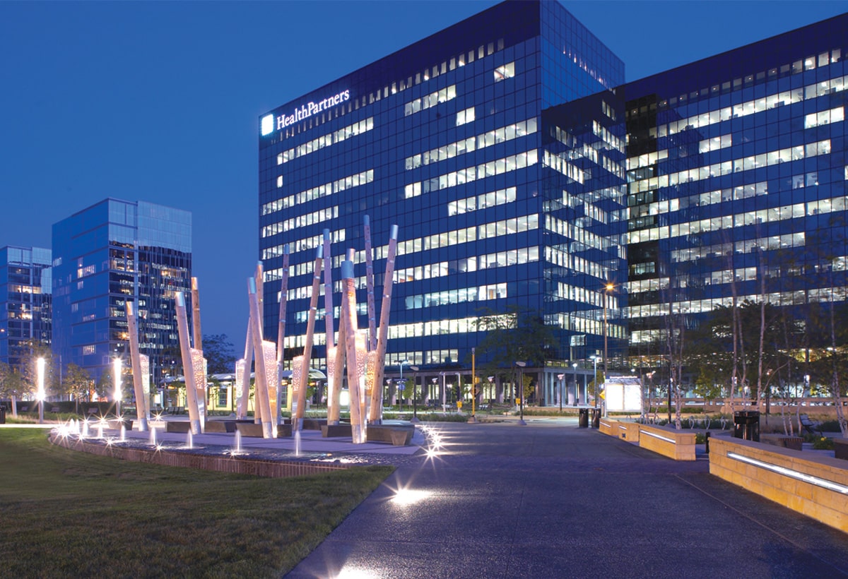 Exterior image of an office building in the evening with well-maintained landscaping.