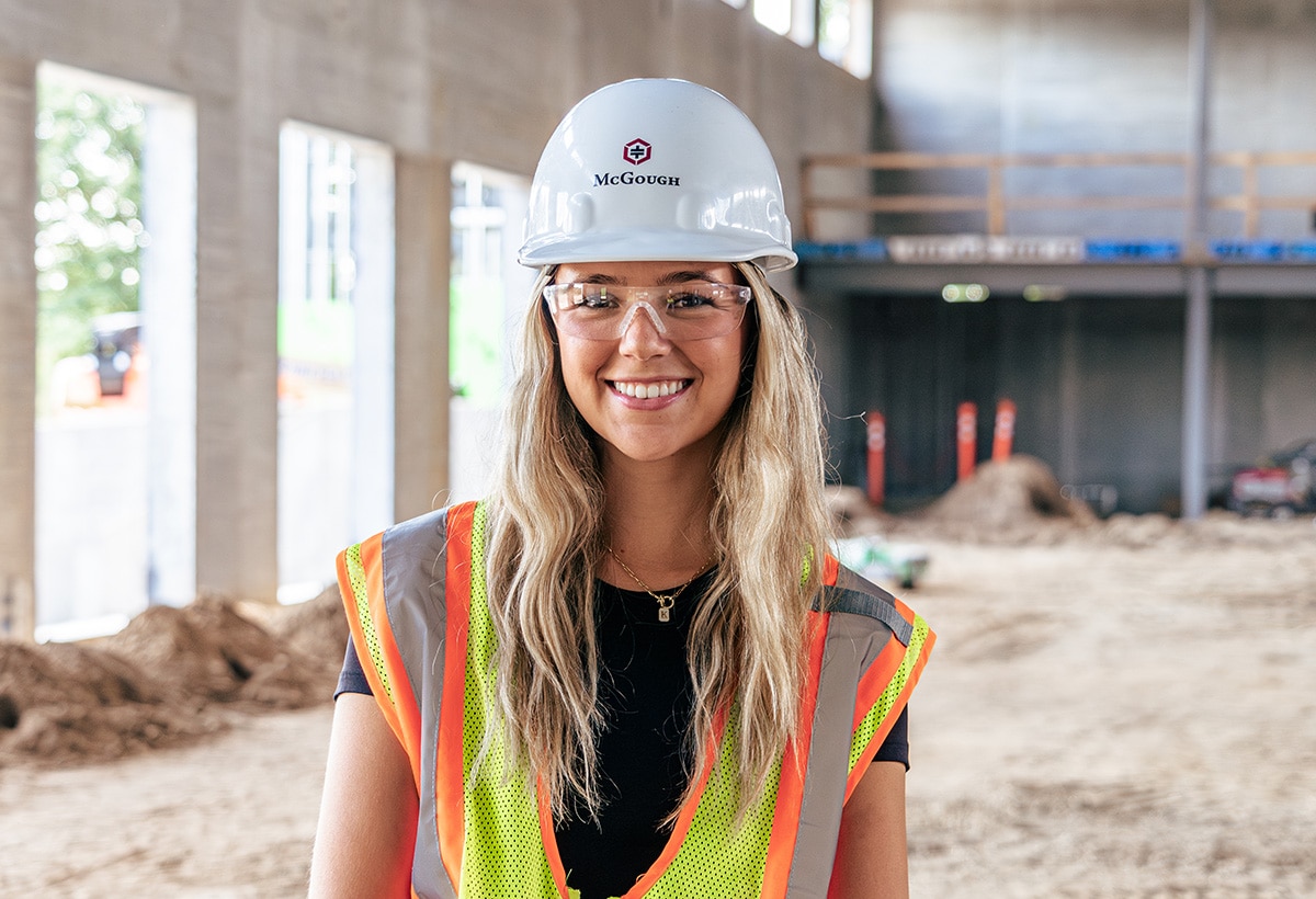 Image of McGough intern Brady Schurhammer, wearing hard hat and yellow vest