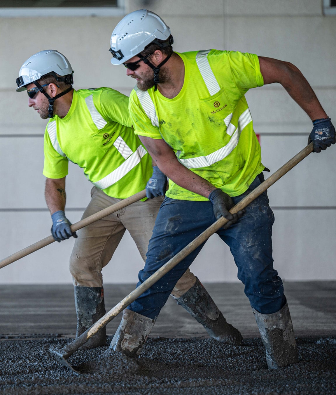 Bearded McGough construction worker in sunglasses on a platform inspecting work
