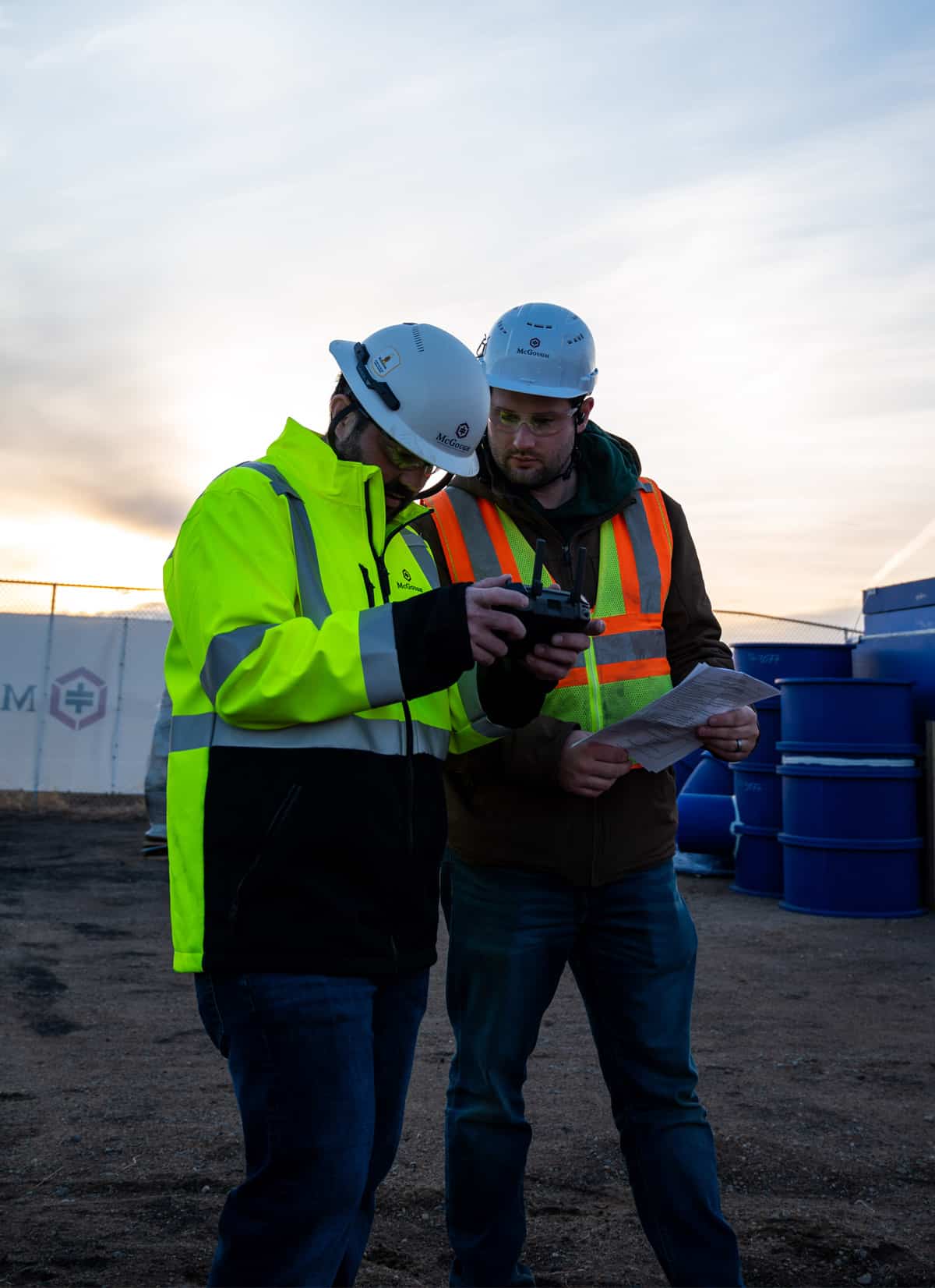 McGough engineer on a job site using handheld electronic measurement devices