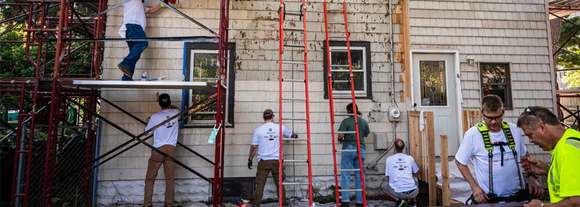 Group of people working on a volunteer housing project