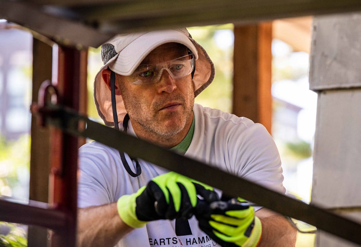Man painting at a volunteer housing project