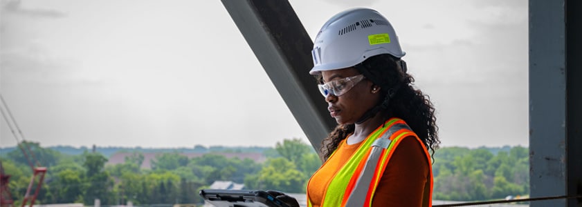 McGough engineers on a job site talking and pointing
